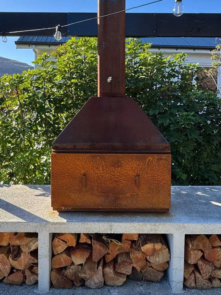 Outdoor corten fireplace on a stone bench